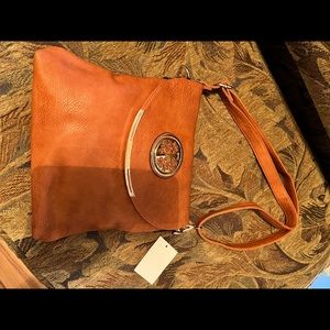 Beautiful camel colored purse trimmed in gold. Brand new.